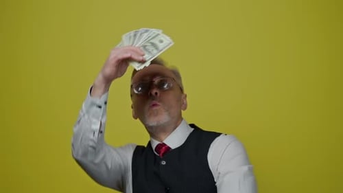 Adult Man Fanning Himself With Paper Money
