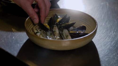 Mussels Being Placed in a Bowl Close Up