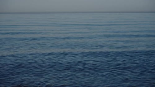 The Ocean Waves Peacefully Under a Clear Blue Sky Creating a Serene Scene of Natural Beauty