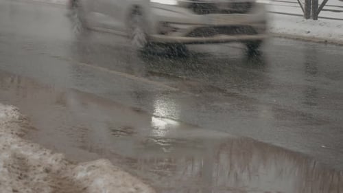 Snow falls and melts on city streets during winter months