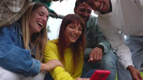 Group of Friends Laughing at Mobile Phone Screen