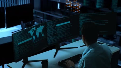 Side View Of Asian Man Having Headache While Write Code With Multiple Computer Screens In office