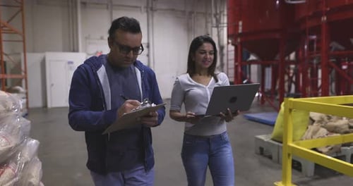 Coffee Roaster Managers Walking and Talking in Food Production Plant 20 Seconds or Greater