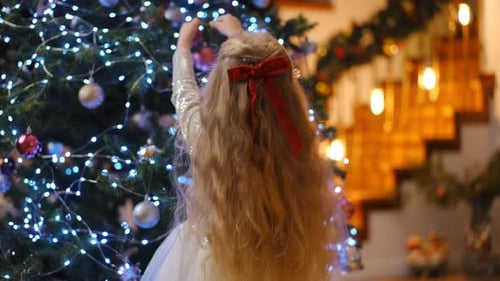 Girl Decorating Christmas Tree at Home