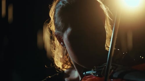 Violinist Playing in Dark Room, Golden Lighting