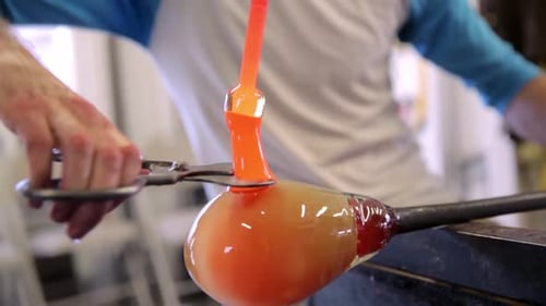 Glassblower Working with Molten Glass to Create Vase