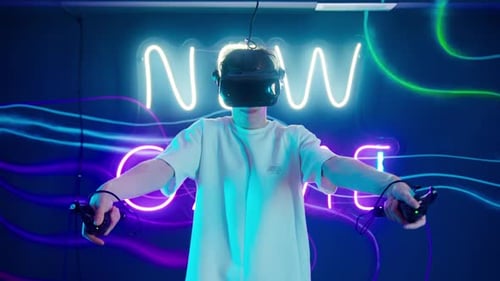 Young Adult Using VR Headset with Neon Lights