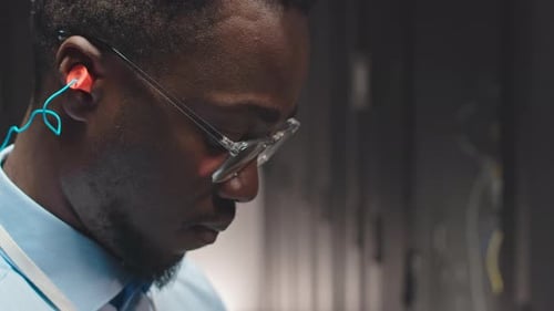 Close Up of Person Wearing Glasses and Earplugs