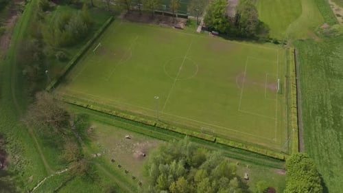 Aerial view of soccer field with trees and grass, Netherlands.