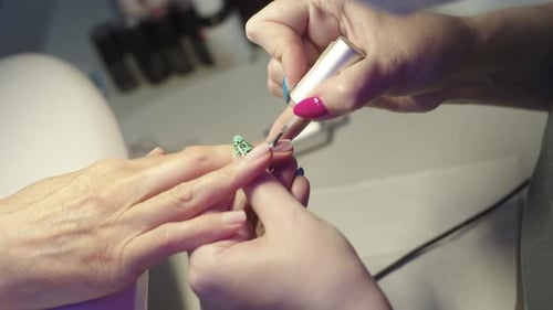 Applying Clear Coat to Client's Animal Print Nails