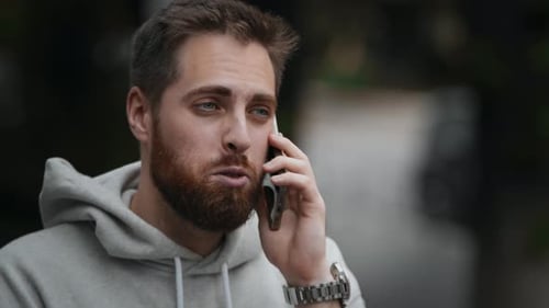 Close-up man is negotiating on the phone, young freelancer businessman
