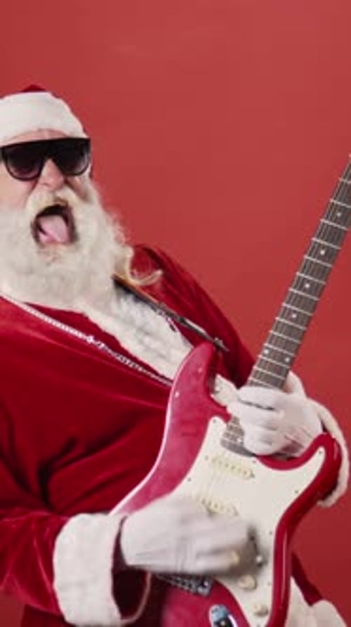 Funky Santa in Sunglasses Playing Electric Guitar and Rocking to Christmas Song