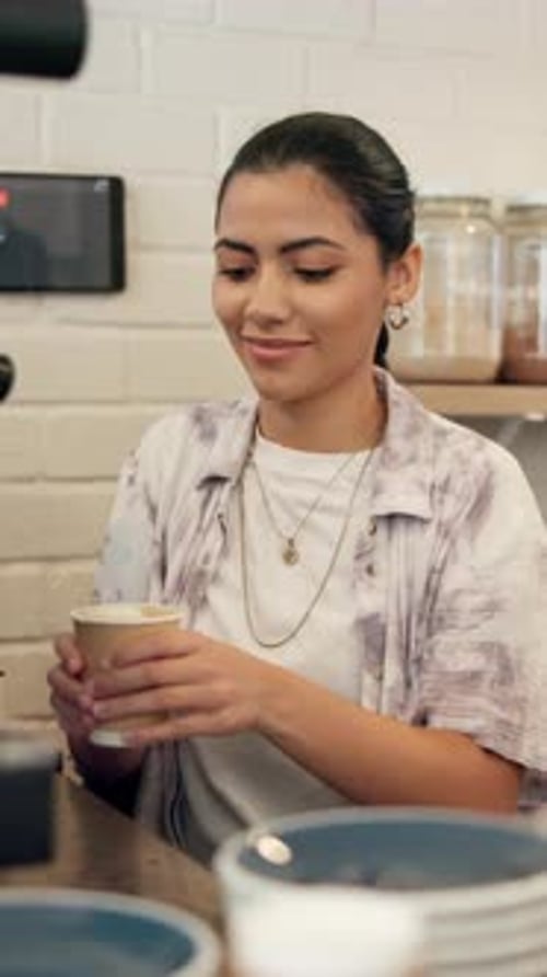 Happy, woman and barista with latte, coffee shop and purchase of hot beverage, takeaway and morning
