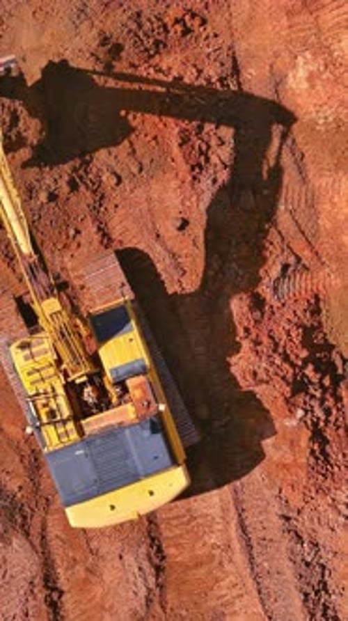 Preparing Area for Built Home Excavator Loads Earth Into Dump Truck on Construction