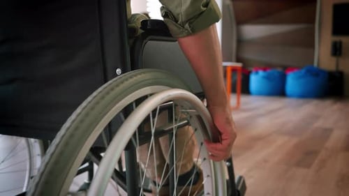 Adult Uses Wheelchair in Bright Home