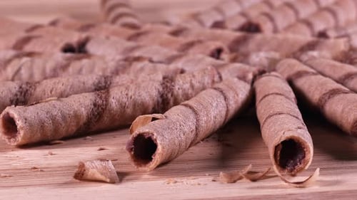 Crispy Chocolate Wafer Rolls on a Wooden Surface