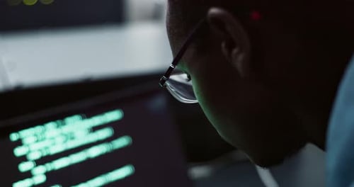 Black man, glasses and computer with coding in office for cybersecurity