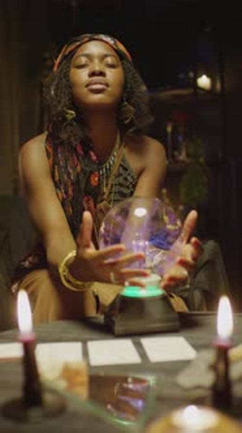 Vertical Shot of African American Clairvoyant Touching Crystal Ball