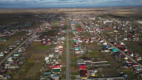 Aerial View of a Village with Residential Houses Showcasing a Serene Countryside Landscape