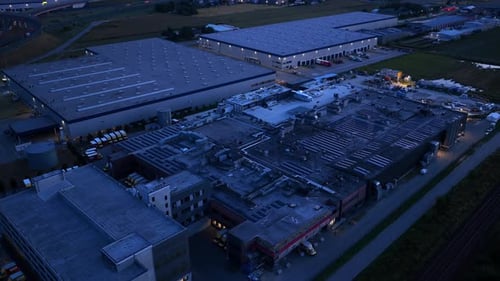 Aerial Drone View of Warehouses and Industrial Buildings at Dusk in Warsaw, Logistics Facilities