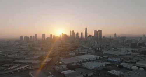 a city with buildings and a sunset