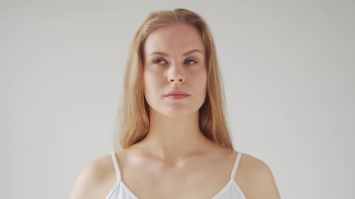 Woman Ponders with Hand on Chin Close Up