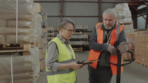 Storage Specialists Talking to Each Other during Working Day