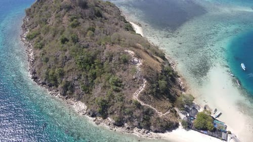 Aerial view of beaches and tourist boat sailing in Kelor Island, Flores Island, Indonesia.