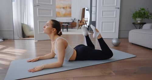 Woman Doing Yoga on Mat Indoors