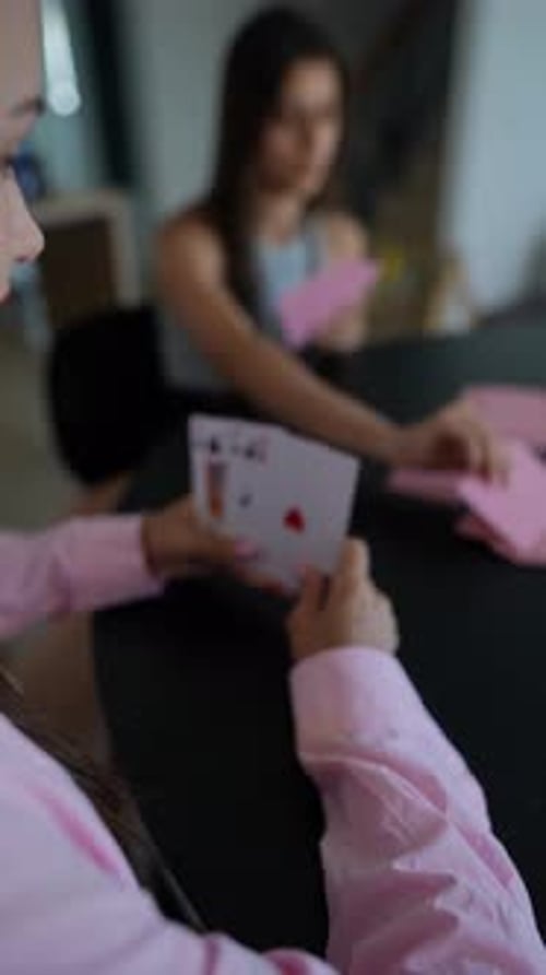 Women Play Card Game Concentrating on Table Competitive Gestures and Expressions Shown
