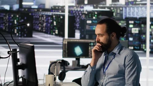 Data Center Technician Discussing with Coworker in Workspace