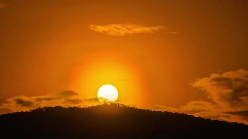 Dramatic Sunrise Over Silhouette of Mountain Range