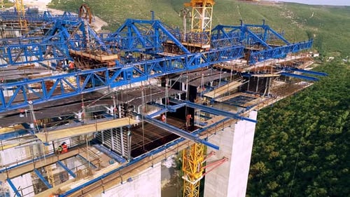 Aerial view of viaduct construction with steel structure and cranes