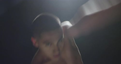 Young couple dances ballet in a studio with smoke and backlight.