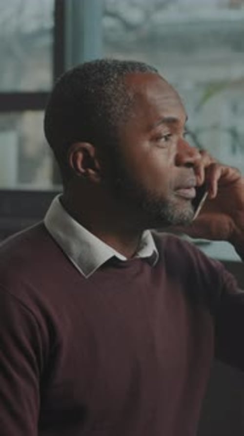 Man Talking Angrily on Cell Phone Indoors