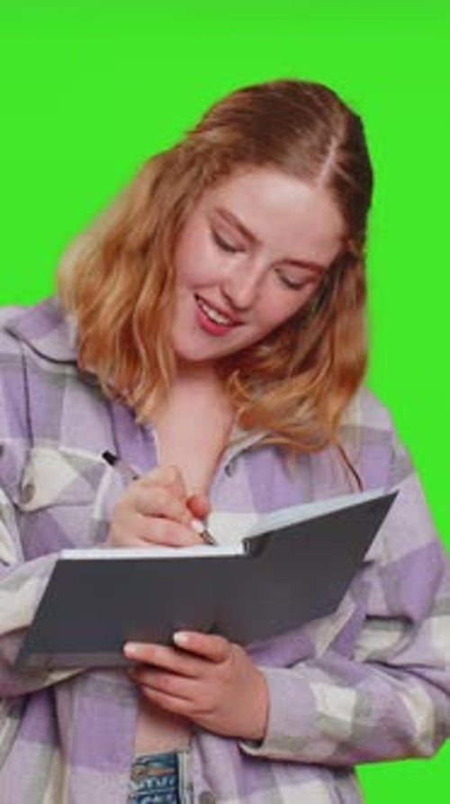 Woman with Notebook Thinks, Writes on Green Screen
