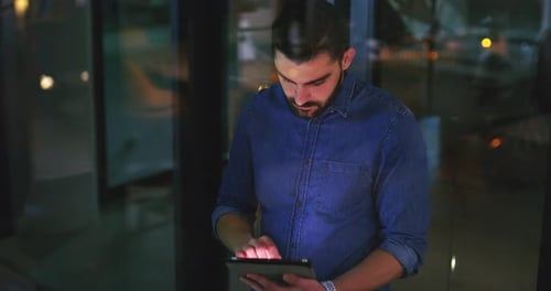 Professionals Working Together at Night in Modern Office