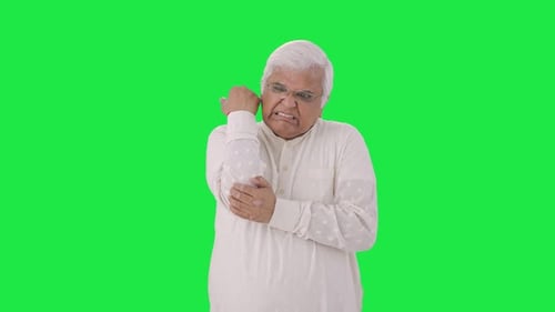 Sick Indian old man suffering from arthritis Green screen