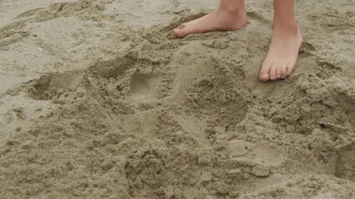 Child Digging in Sand at Beach. on Red Epic for High