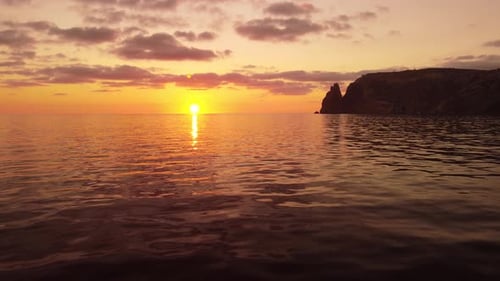 Aerial View on Sunset Over Calm Sea and Volcanic Rocky Shores