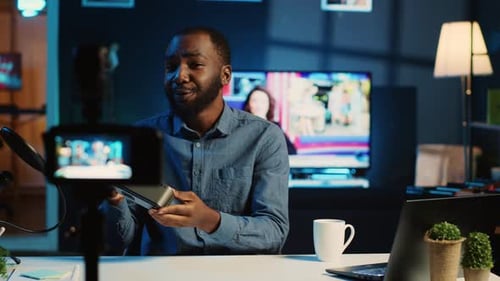 Man Records Vlog About New Technology in Office