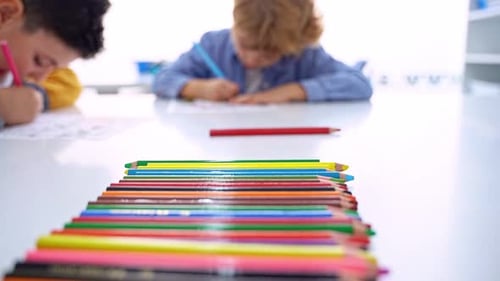 Children Drawing Paint with Colorful Pencils Coloring Book in Educational Class at School