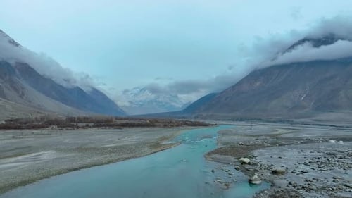 Aerial View Of Hunza River Flowing Through Nomal Valley Landscape In Gilgit. Push Forward Shot