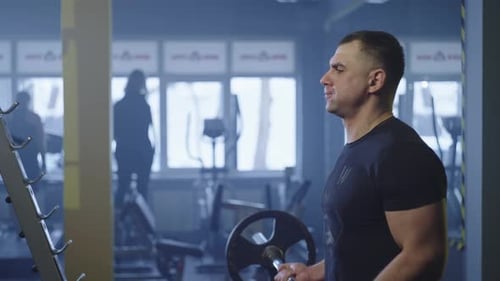 Senior Caucasian Man Doing Barbell Exercises in the Gym