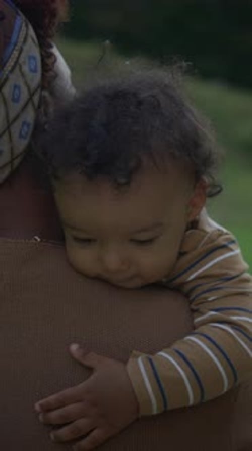 Mother Cradling Child Outside