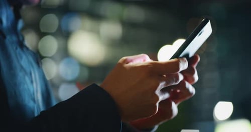 Slow motion close up of  an young man hands using a smartphone phone in a center of the city by n
