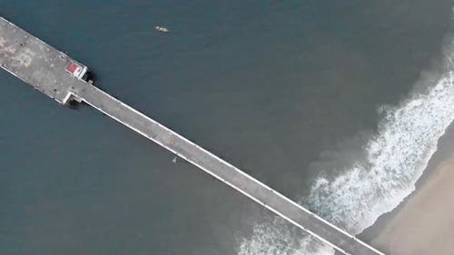 4k Aerial Top Down Dolly Moving forward shot of a Shipping Port Pier on a Sunrise with monsoon cloud