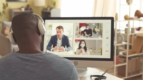 Businessman Having Video Meeting with Colleague on Computer