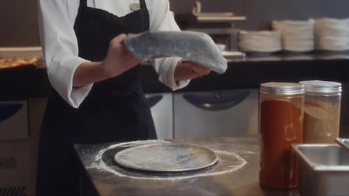 Unrecognizable Pastry chef Kneading Dough at Restaurant Kitchen
