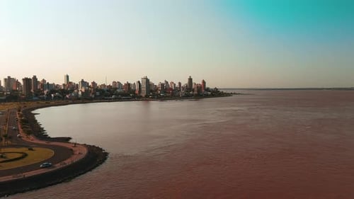 A stunning skyline view of Posadas gracing the banks of the Paraná River.
